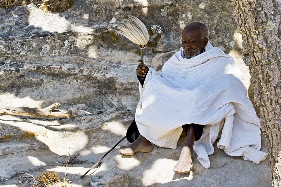 109   Old priest seeking rest in the shade. (near Yohannes Maequddi Rock hewn church)  Ethiopia 